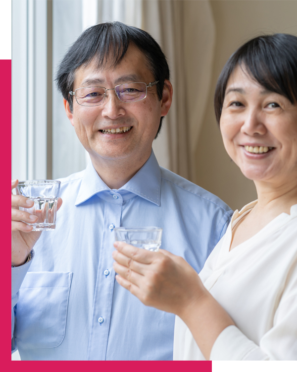 Couple from Georgia smiling with clean glass of water