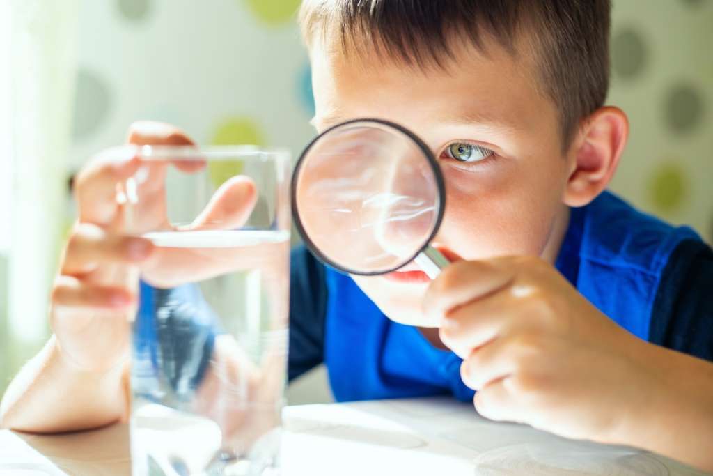 is water filtration worth it- boy with magnifying glass