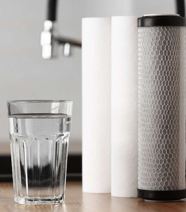 A glass of clean water and water filter cartridge