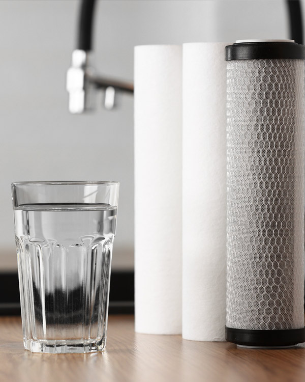 A glass of clean water and water filter cartridge