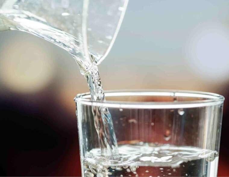 Pitcher pouring into glass of water