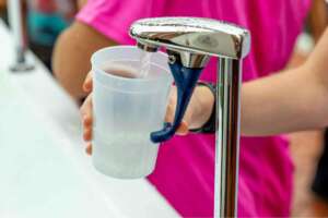 Filling a drinking glass with filtered water at home