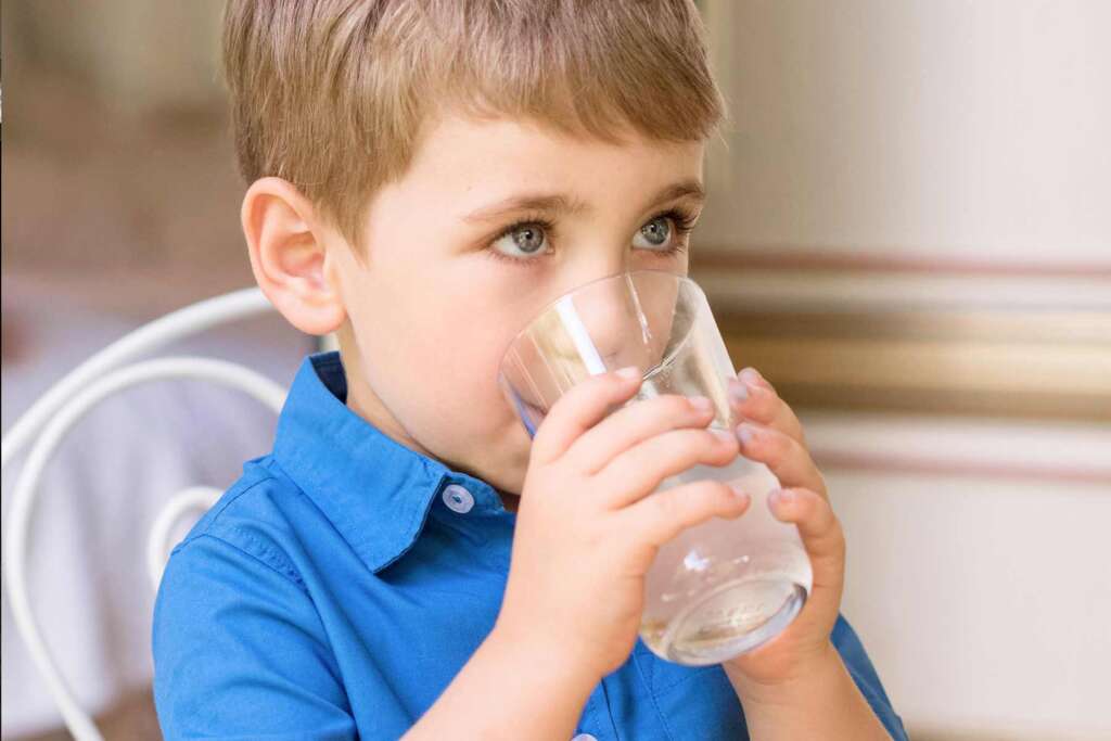 A boy kid drinking clean water