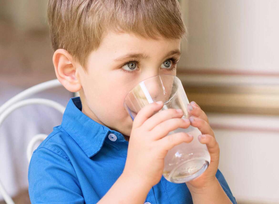 A boy kid drinking clean water