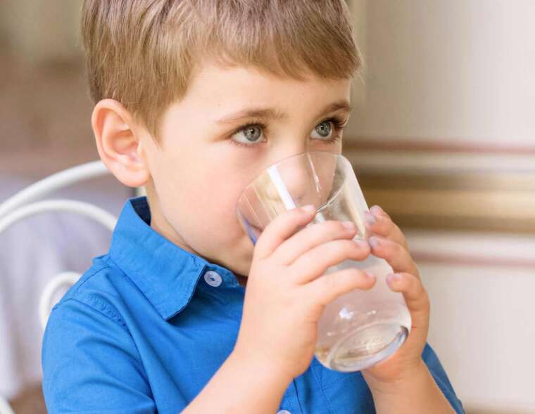 A boy kid drinking clean water