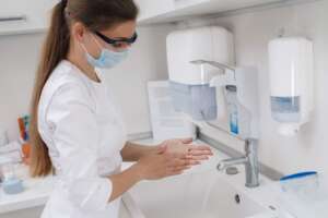 A female healthcare worker washing her hands with filtered tap water