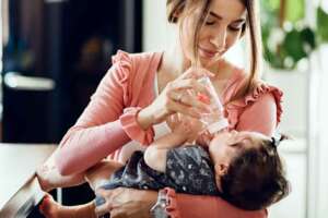 A mom bottle feeding her baby