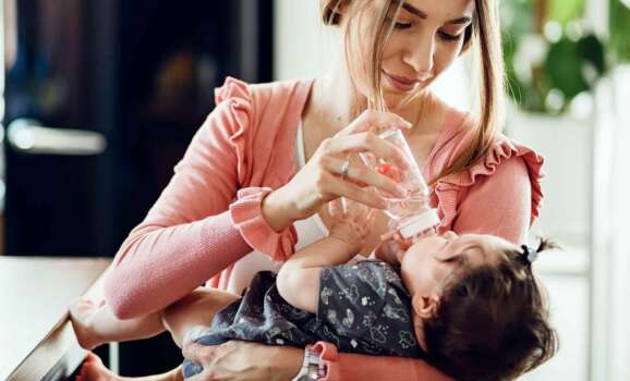 A mom bottle feeding her baby