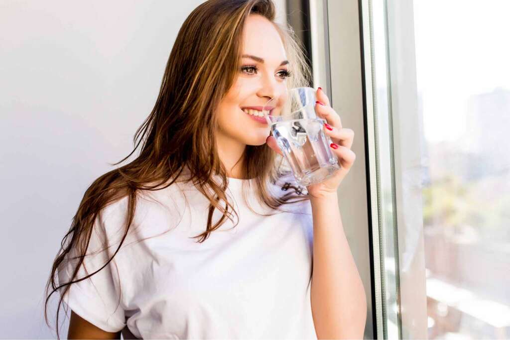 A woman drinking filtered well water