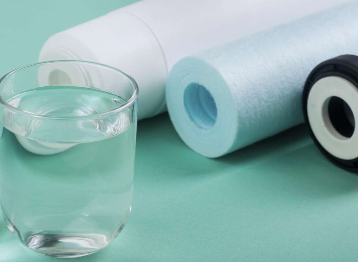 A glass of filtered water and reverse osmosis filters