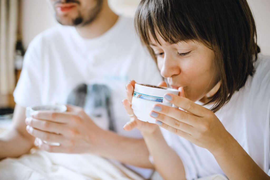 Couple drinking tea from ceramic cups made with safe, filtered water