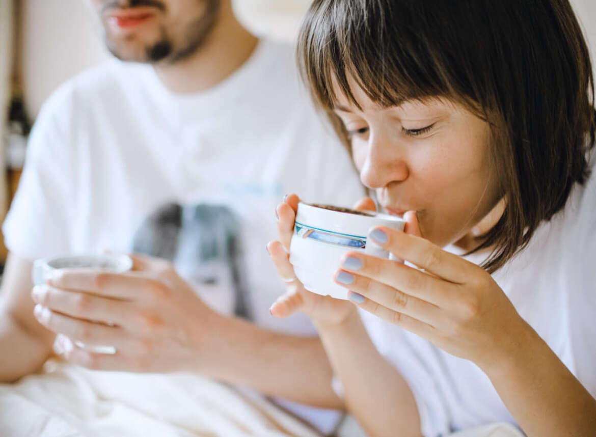 Couple drinking tea from ceramic cups made with safe, filtered water